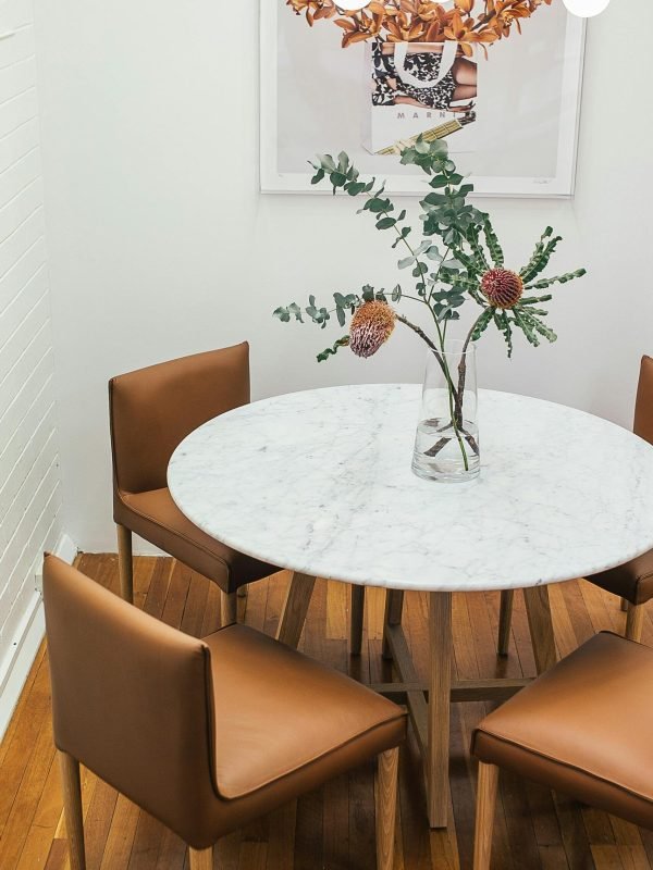 modern-furniture-marble-table-leather-chairs Modern dining furniture set with a marble-top table and tan leather chairs.